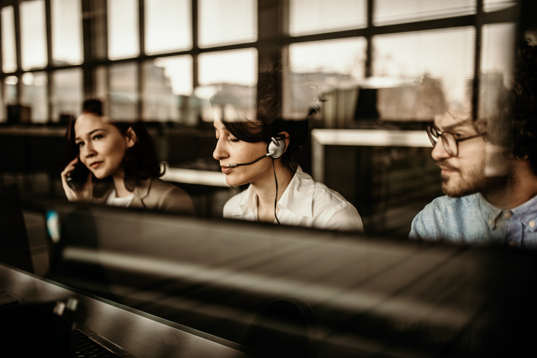 IT support team with headsets focused on 24/7 monitoring and productivity